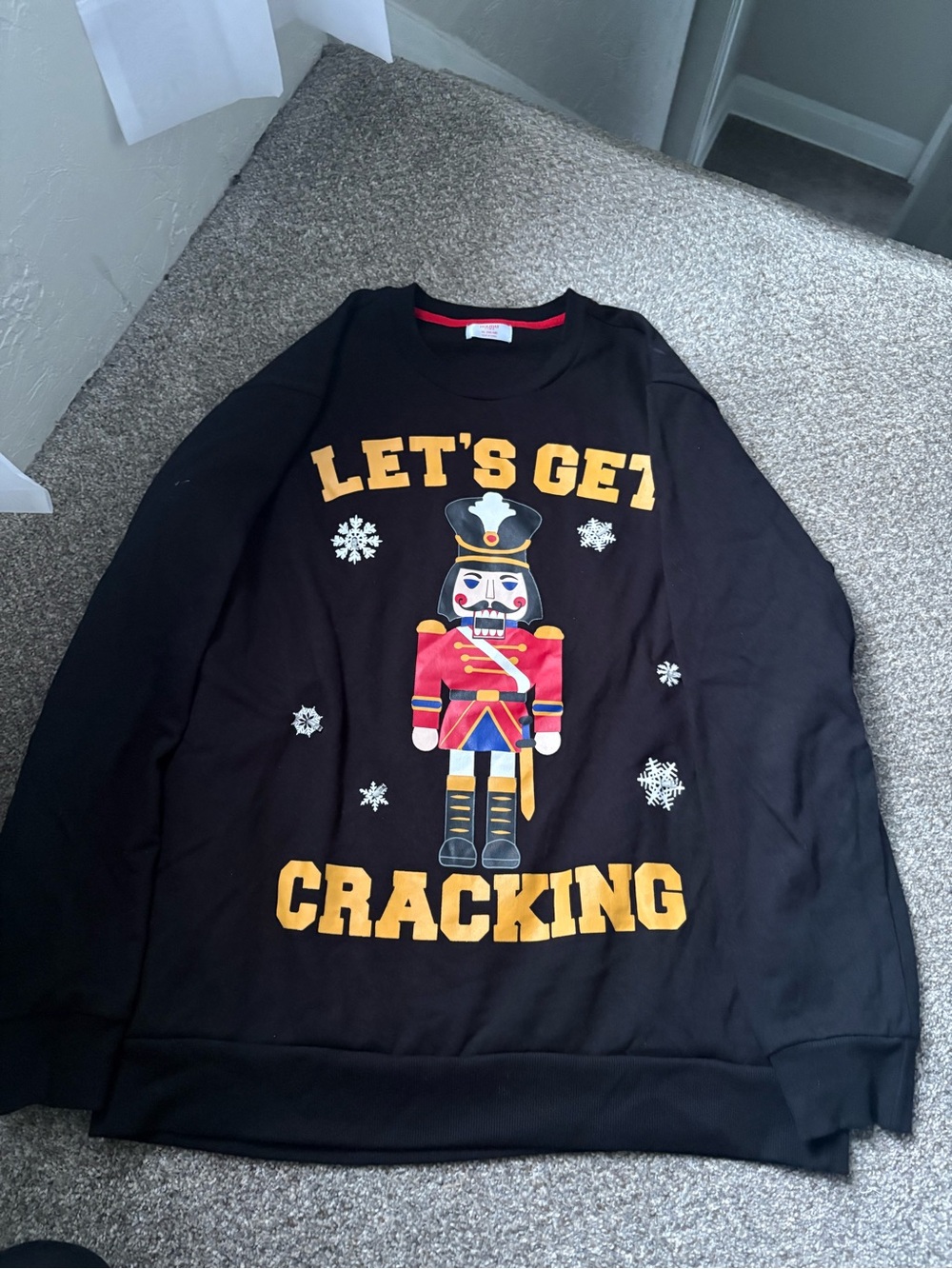 Holiday Time Black Crewneck Nutcracker Graphic Sweater with Yellow Text